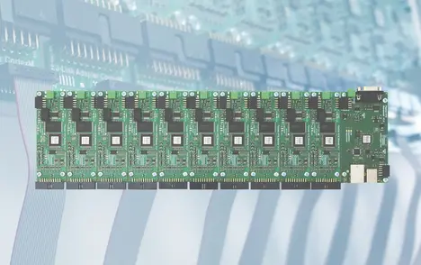 The image features a green circuit board composed of multiple interconnected microcontrollers and components. It is designed for electronic applications, with various connectors and chips visible for functionality. The background shows a blurred pattern of more circuit boards.