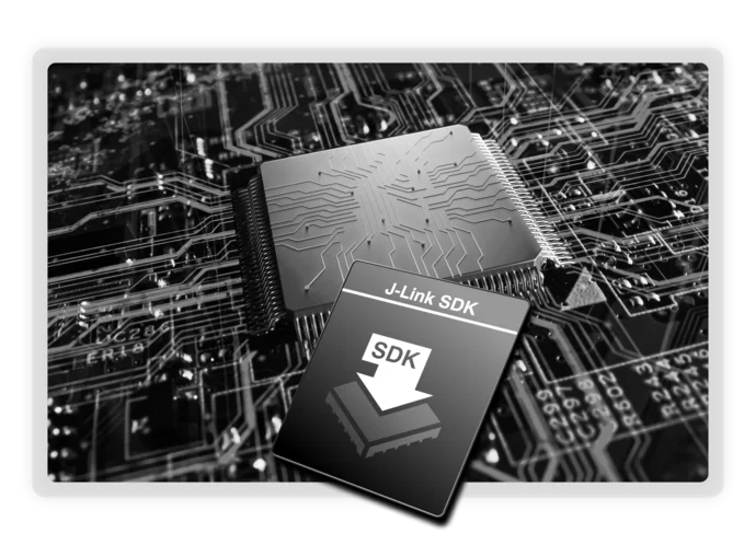 A close-up image of a computer microchip on a circuit board, featuring intricate pathways. Overlaying the image is a graphic displaying "J-Link SDK" with a downward arrow symbol, indicating software development resources related to the microchip.
