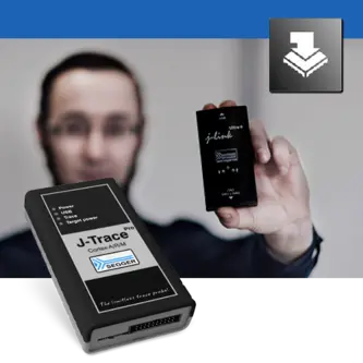 A person holds a small device labeled "J-Link" in one hand, while a larger device labeled "J-Trace" is in the foreground. The background features a blurred figure, emphasizing the devices used for debugging and programming in embedded systems.