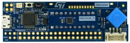 The image displays a blue electronic development board featuring various components, including a microcontroller chip, connectors, and buttons. The board is designed for programming and experimentation, with multiple pin headers for connectivity and an STMicroelectronics logo visible at the top.