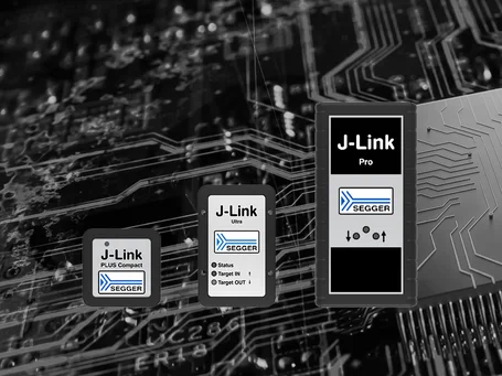 Three J-Link devices (Plus Compact, Ultra, and Pro) are displayed on a dark circuit board background. Each device features a labeled front, indicating different functionalities. The setting emphasizes their connectivity and technological purpose.