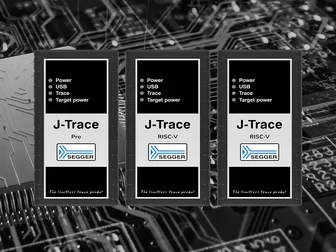 Three J-Trace devices displayed on a circuit board background. Each device has a black and silver design with labels: "J-Trace Pro" and "J-Trace RISC-V," indicating features like Power, USB, Trace, and Target power. The SEGGER logo is also present.