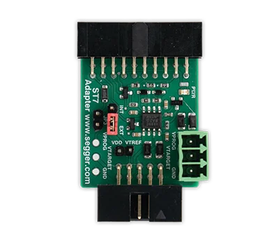 A green electronic adapter board featuring various connection pins, including JTAG and power ports. The board has multiple small components and labels indicating functionalities such as VDD, VTREF, and GND. The product is designed for programming and debugging microcontrollers.