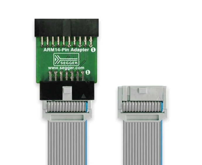 An ARM14-pin adapter with a green circuit board on top, featuring pin connectors. It is connected to a gray ribbon cable that has two connectors at either end. The adapter is for interfacing with ARM devices in electronic projects.
