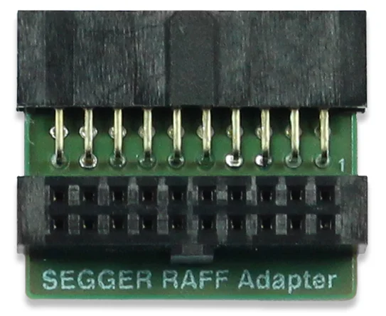 Image of a SEGGER RAFF Adapter. It features a small green circuit board with two rows of metal pins on top and a black connector at the bottom. The text "SEGGER RAFF Adapter" is printed on the board, indicating its purpose for hardware connections.