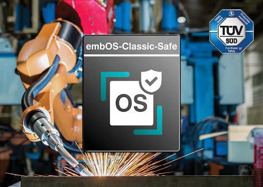 Image features a factory setting with robotic arms working on metal components, producing sparks. In the foreground, a logo for "embOS-Classic-Safe" is displayed prominently, accompanied by a certification badge from TÜV SÜD, indicating safety standards.