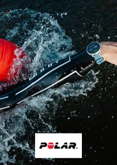 A person in a red wetsuit is swimming in water, reaching out with one hand while wearing a smartwatch. The logo of Polar is displayed prominently at the bottom. The scene conveys an active swimming environment, likely related to fitness or sports.