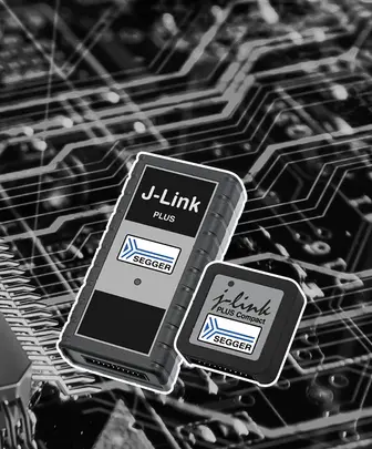 Two SEGGER J-Link devices are displayed: the larger J-Link Plus and the smaller J-Link Plus Compact, both featuring prominent logos. They are set against a background of circuit board patterns, illustrating their application in electronics development and debugging.