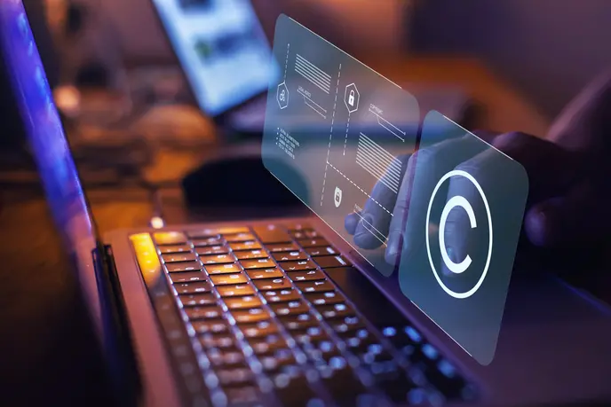 Opened laptop and Copyright icon