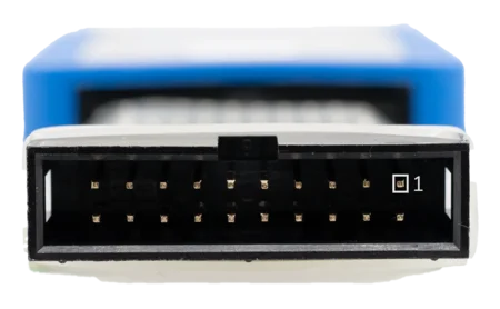 Close-up of a black rectangular connector with multiple gold pins inside. The connector is oriented with the open side facing forward and is labeled with a small number “1” in a square at the right side. The background is slightly blurred, showing a blue object behind.