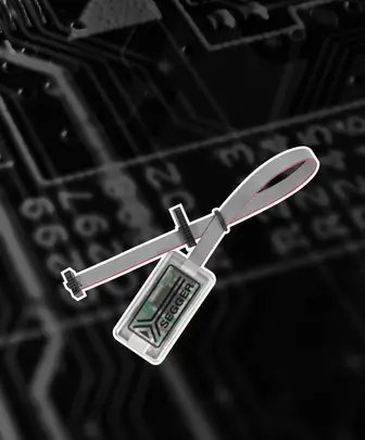 An ID badge with the SEGGER logo is displayed, attached to a gray strap. The background features a black circuit board design, highlighting technology themes.