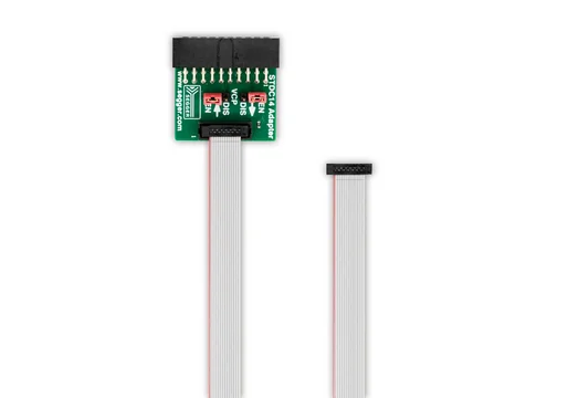 Image shows a STDC14 Adapter with a green circuit board featuring connection points and labels for "EN," "DIS," and "V0." A flexible ribbon cable is connected to the adapter, with the other end exposed and unconnected. The background is plain white.