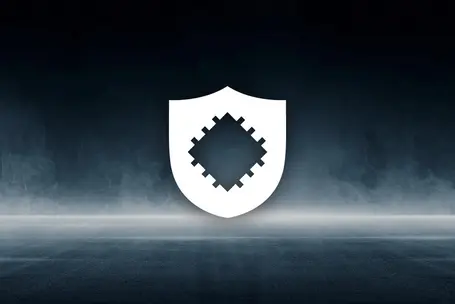 A minimalistic white shield icon is centered in the image. The shield features a pixelated, diamond-shaped pattern in the middle, set against a dark, smoky background. The design conveys themes of protection and digital security.