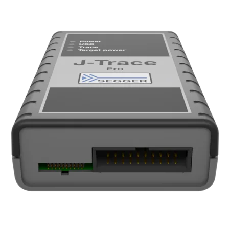 A rectangular electronics device labeled "J-Trace Pro" by SEGGER, featuring indicator lights for power, USB, trace, and target power. One end has a connector with gold pins. The device has a gray and black color scheme with a textured surface for grip.
