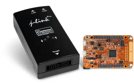 The image features a black j-link debugger device with indicators for LAN and USB connections. Next to it is an orange microcontroller board with various components and connectors, designed for development and debugging in embedded systems.
