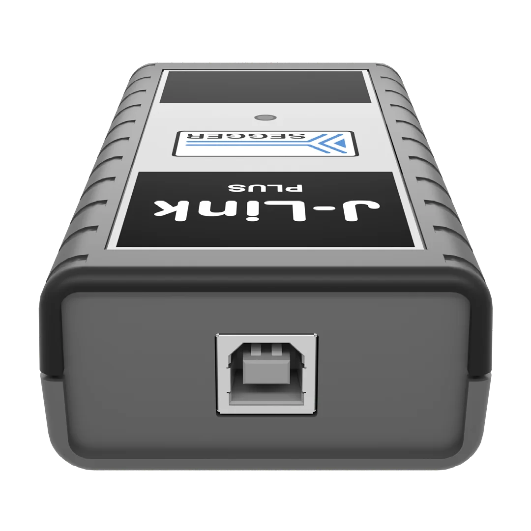 A gray electronic device with a rectangular shape. The front features a prominent USB port in the center and a label displaying "J-Link" and "Unit" above it. The device's surface has a textured grip, suggesting durability.