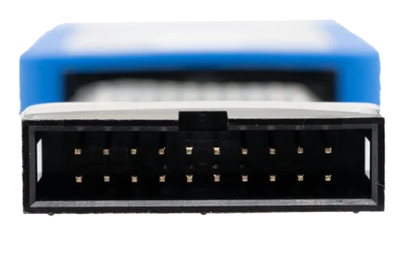 Close-up of a black multi-pin connector, showing rows of shiny gold pins inside a rectangular opening. The background features a blue object, slightly blurred, providing context to the connection.