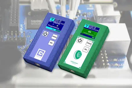 The image features two electronic devices on a circuit background. The blue device displays "Programming..." with a progress indicator, while the green device shows "OK" with a completion message. Both devices have buttons labeled "PROG" and "SEL," and are designed for technical programming.
