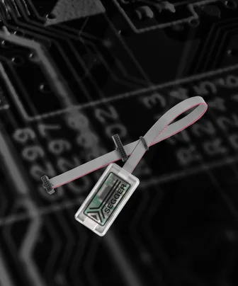 An ID badge with the SEGGER logo is displayed, attached to a gray strap. The background features a black circuit board design, highlighting technology themes.