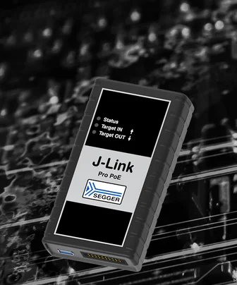 A black device labeled "J-Link Pro PoE" with indicator lights for "Status," "Target IN," and "Target OUT." It is used for remote debugging in electronics. The background features subtle circuit patterns, emphasizing the device's technological context.