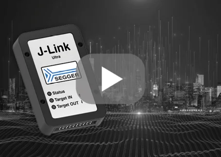 Alt text: A close-up of a J-Link Ultra device from SEGGER, displaying connection statuses and ports labeled "Status," "Target IN," and "Target OUT." The background features a modern city skyline with digital sound waves, emphasizing a tech-focused theme.