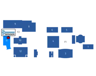 A layout map highlighting various exhibit booths at an event. SEGGER is located at booth 11. Other booths are numbered from 1 to 12 and labeled with numbers such as 4, 5, 6, and F1, with grouped areas identified.