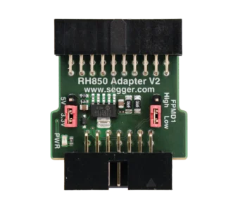 A green circuit board labeled "RH850 Adapter V2" featuring a central chip, several pins for connections, a red switch, and markings for power and signal settings. The design includes a connector at the bottom for interfacing with other devices.