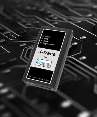 A black device labeled "J-Trace Pro" with various connection ports and indicators (Power, USB, Trace, Target power) sits against a circuit board background, emphasizing its function related to electronics debugging and tracing.