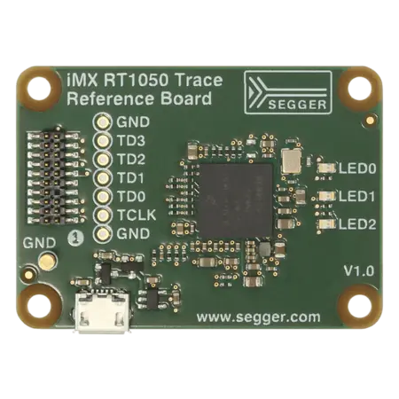 Image of the iMX RT1050 Trace Reference Board featuring various electronic components. The board includes labeled pins, a micro USB connector, and three LEDs. It has a dark green background with white text indicating the brand, model, and version.