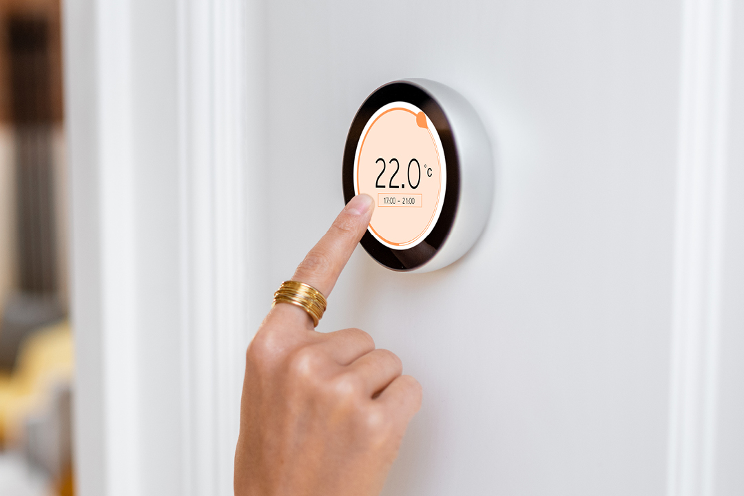 Production programming for IoT edge devices Finger touches thermostat